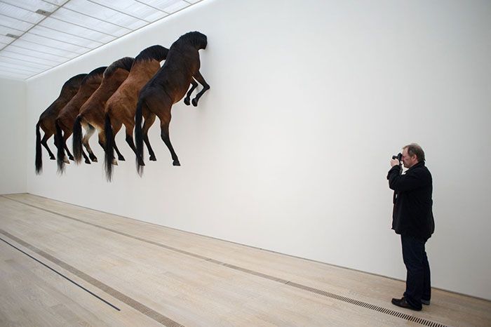 A photograph shoots an art project by Italian artist Maurizio Cattelan at the Beyeler Foundation in Basel on June 10, 2013 during a press day for the Art Basel 2013 international art show, which opens to the public on June 13. AFP PHOTO / SEBASTIEN BOZON RESTRICTED TO EDITORIAL USE, MANDATORY MENTION OF THE ARTIST UPON PUBLICATION, TO ILLUSTRATE THE EVENT AS SPECIFIED IN THE CAPTIONSEBASTIEN BOZON/AFP/Getty Images ORG XMIT: 409