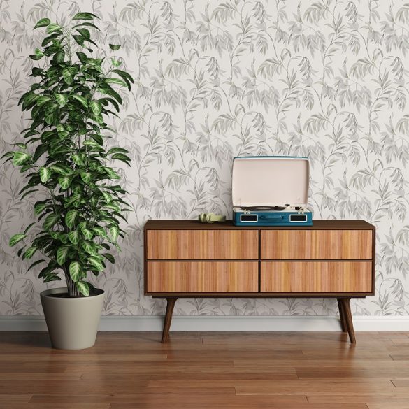 zona de mueble con planta y pared con papel pintado floreado