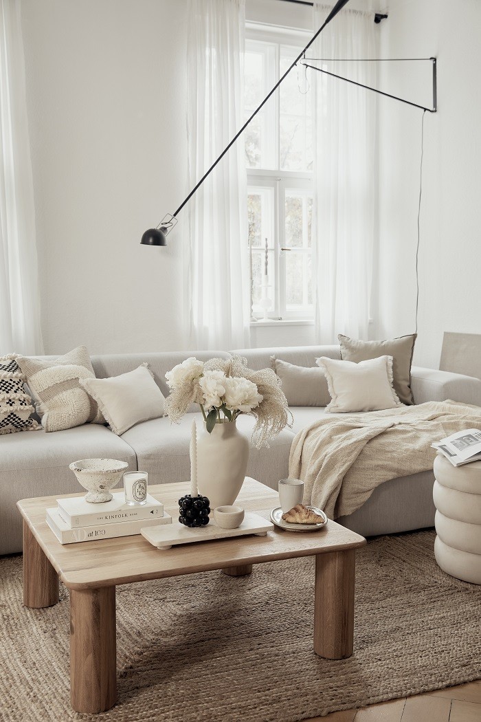 Salón con sofá con cojines con un estilo moderno raw