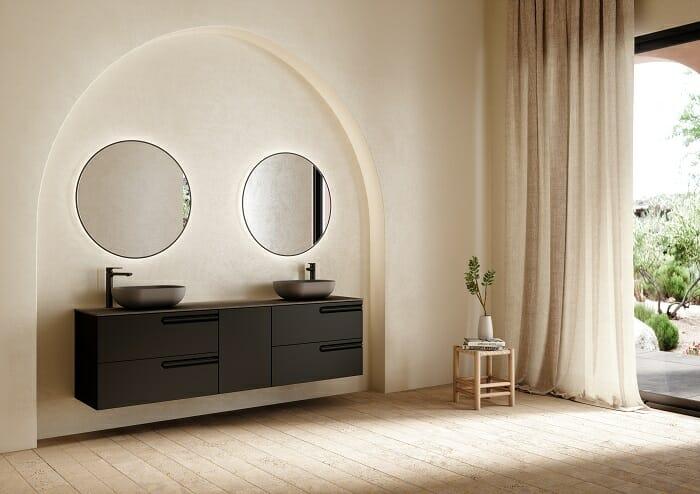 Cuarto de baño con un lavabo de diseño en color gris oscuro con dos espejos redondos