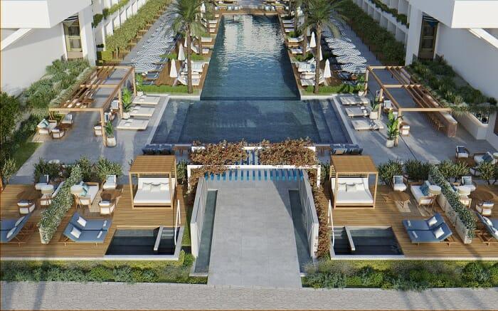 Vistas de la piscina Azure Beach en el Hotel Mett en Marbella con palmeras