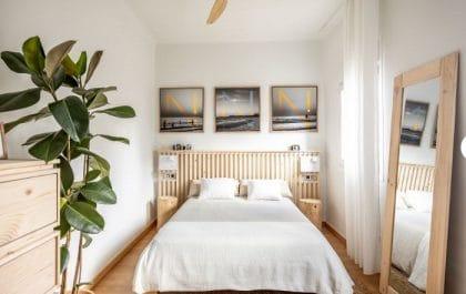 Dormitorio reformado con planta y paredes blancas