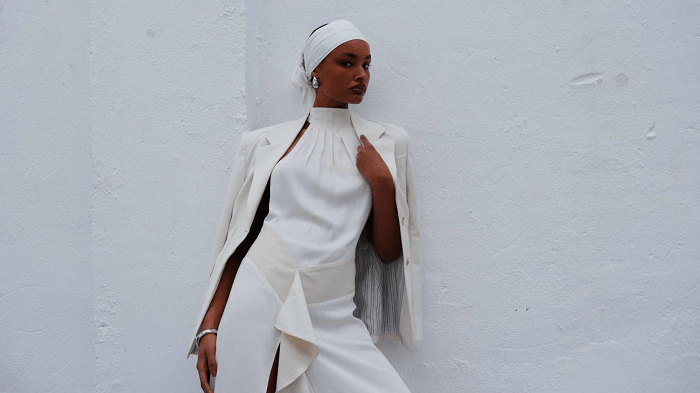 Modelo de raza negra con un vestido blanco y pañuelo blanco en la cabeza
