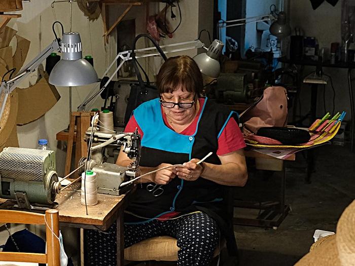 Mujer mayor tejiendo un producto artesano